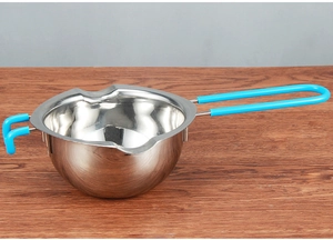 Close-up of 304 stainless steel melting pot with blue handle on wooden background