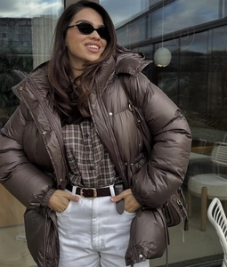 Detail of deep brown hooded jacket with drawstring waist and zip fastening design