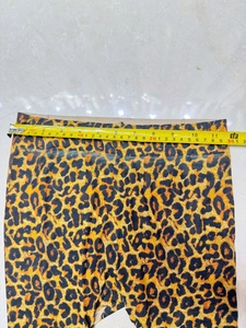 Flat lay of leopard print pantyhose with measuring tape showing waist size 30cm