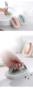 Detail of pink and blue cleaning sponge brush with ergonomic handle for bathtubs