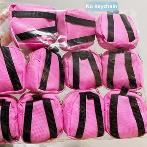 Detail showing bulk pack of 12 pink mini backpack coin purses without keychains