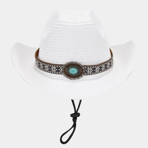 Macro detail of white straw cowboy hat with ethnic turquoise leather band and chin strap