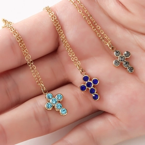 Minimalist stainless steel necklace featuring cross pendants with blue and gray rhinestones