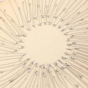 Ensemble de 26 colliers argentés avec lettres de l'alphabet et petits pendentifs cœur