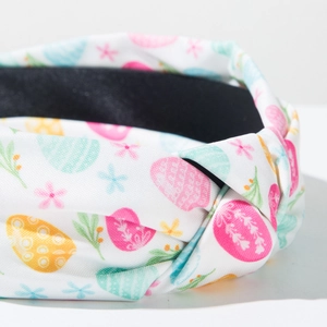 Detail of fabric knot on Easter egg print headband with floral and leaf patterns