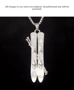 Detailed macro of stainless steel ski board pendant with engraved snowflake patterns