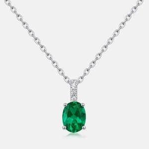Elegant silver necklace with oval emerald green gemstone and sparkling zircon accents