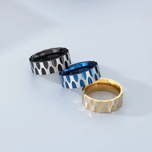 Three minimalist stainless steel rings with water ripple texture in black blue and gold