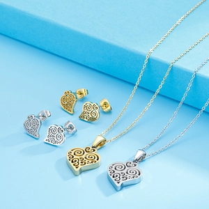 Close-up of heart-shaped hollow twisted jewelry sets in gold and silver steel finish