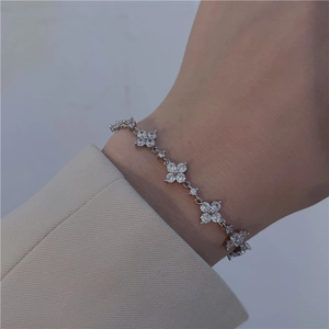 Detailed view of a silver floral bracelet set with sparkling zircons on a model wrist