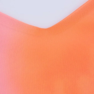 Macro detail of the lightweight chiffon fabric showing a vibrant pink and orange gradient