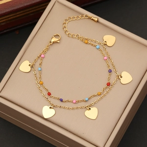 Double-layered gold heart bracelet with colorful beads on a premium display box
