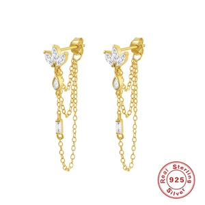 Macro shot of 925 sterling silver tassel earrings with zircon flower and gold finish