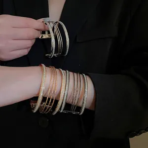Multilayered metallic open bangle bracelet with sparkling glitter finish for women