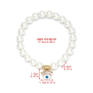 Detail view of woven pearl bracelet with blue evil eye pendant showing size measurements