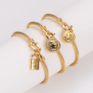 Three-piece golden cable bracelets set with lock and coin pendants for women