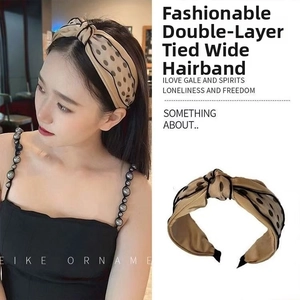 Detailed close-up and model view of the beige polka dot knotted wide headband