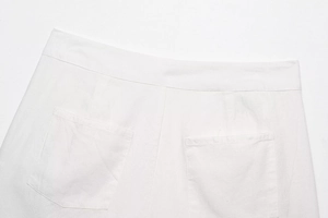 Detailed view of the back pockets and woven fabric on white high-waist shorts