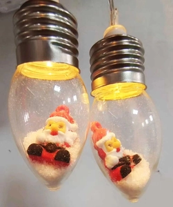 Detail of LED Christmas bulb with miniature Santa and artificial snow inside