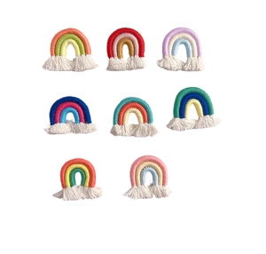 Macro display of eight handmade colorful rainbow macrame keychains with cotton tassels
