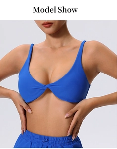 Detail view of bright blue ribbed sports bra featuring front twist and slim straps