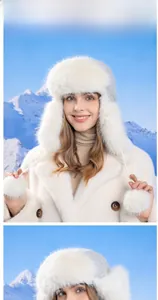 Close-up of a white plush trapper hat with pom-pom ties and faux fur lining for winter