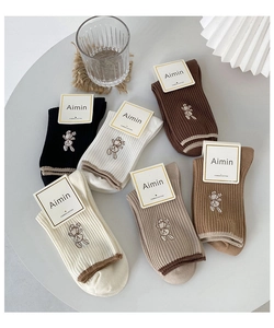 Detailed view of combed cotton socks with cute rabbit embroidery in six neutral colors