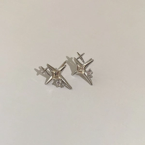 Detailed view of silver star stud earrings with central square zircon and small accent stones