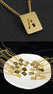 Macro view of 18K gold plated square initial pendant showing 26 alphabet letter options