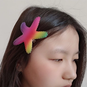 Colorful gradient starfish hair clip with rainbow sequins for girls, worn on long hair
