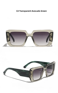 Detail view of oversized square sunglasses with avocado green frames and gradient lenses