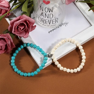 Close-up of magnetic natural stone bracelets for couples with turquoise and marble beads