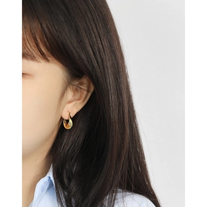 S925 sterling silver twist hoop earring in gold with black stripes worn by a model