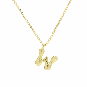 Close-up of 18k gold plated pendant featuring a fluid 3D puff letter H balloon design