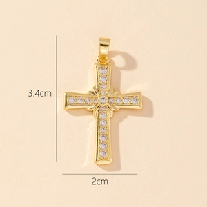 Detail view of a gold-plated cross pendant with clear cubic zirconia and size dimensions