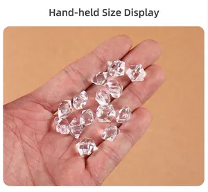 Hand-held view of clear acrylic faux ice cubes showing size scale and textured surface