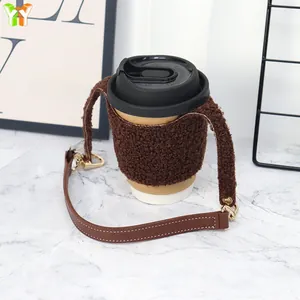 Plush lamb wool coffee cup sleeve in chocolate brown with durable leather handle