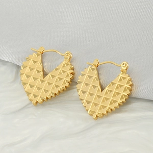Golden heart earrings with textured pyramid pattern in stainless steel design
