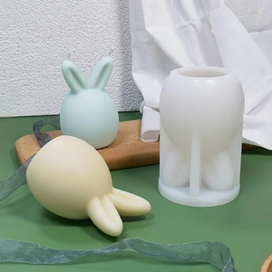 Detail showing white silicone mold with finished mint green and yellow rabbit candles