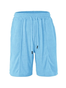 Detail of light blue jacquard shorts showing textured fabric and elastic drawstring waist