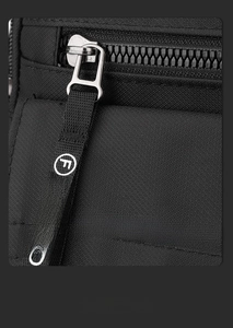 Close-up of black nylon shoulder bag featuring heavy-duty zipper and fashion letter print