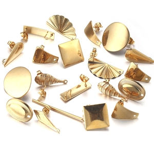 Detailed view of various gold-plated geometric earring posts and DIY craft accessories