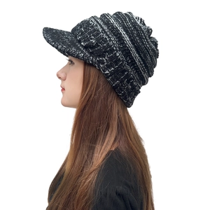 Detail of chunky knit peak hat with side braided texture for winter warmth