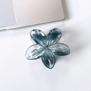 Close-up of translucent gradient blue plumeria hair claw clip with glossy resin finish