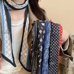 Close-up of patterned skinny silk scarves in floral, geometric, and polka dot styles