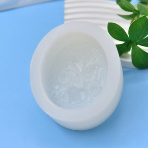 White silicone mold for candles and soap featuring embossed rose flowers and butterfly designs