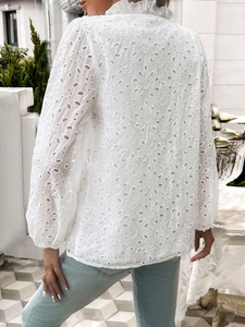 Detail of white hollow-out embroidery blouse with ruffle back and stand collar