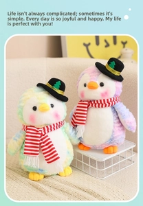 Detail of colorful tie-dye Christmas penguin plush toys with mini hats and striped scarves