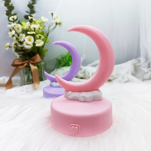 Detail of DIY moon night lights with pink and purple crescents on cloud cloud bases