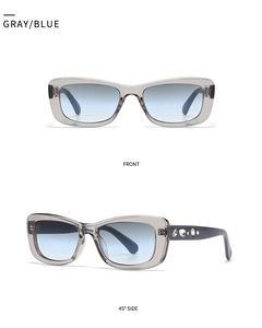 Detail view of small square sunglasses with gray-blue gradient lenses and crystal temple